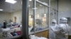 FILE - Medical staff dressed in protective suits talk to each other as they treat coronavirus disease patients at the COVID-19 ICU of Machakos Level 5 Hospital, in Machakos, Kenya, Oct. 28, 2020. 