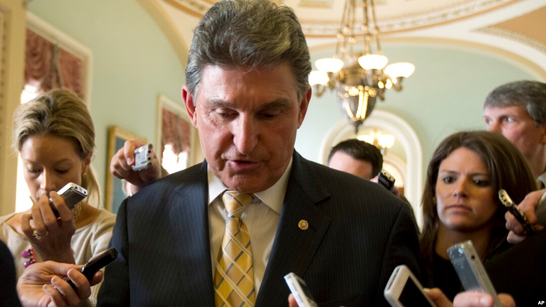 Democratic Senator Joe Manchin of West Virginia is followed by reporters after a meeting on gun control, on Capitol Hill in Washington, D.C., April 9, 2013.