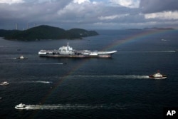 FILE - The Liaoning, China's first conventionally powered aircraft carrier, sails into Hong Kong for port call, on July 7, 2017, to celebrate the 20th anniversary of the People's Liberation Army garrison's presence in the semi-autonomous Chinese city. (AP Photo/Kin Cheung, File)