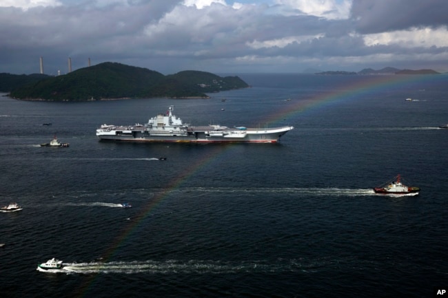 FILE - The Liaoning, China's first conventionally powered aircraft carrier, sails into Hong Kong for port call, on July 7, 2017, to celebrate the 20th anniversary of the People's Liberation Army garrison's presence in the semi-autonomous Chinese city. (AP Photo/Kin Cheung, File)