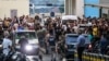 Ambulances are surrounded by people at the entrance of the American University of Beirut Medical Center, on September 17, 2024, after explosions hit locations in several Hezbollah strongholds around Lebanon amid ongoing cross-border tensions between Israe