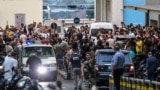 Ambulances are surrounded by people at the entrance of the American University of Beirut Medical Center, on September 17, 2024, after explosions hit locations in several Hezbollah strongholds around Lebanon amid ongoing cross-border tensions between Israe