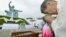 Shigeko Iwamoto, who survived the 1945 atomic bombing of Nagasaki, offers prayers for the victims in front of the Peace Statue in Nagasaki's Peace Park, August 9, 2012. 