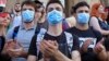 Young opposition demonstrators wearing masks reading "Russia Occupant " gather in front of the Georgian Parliament building in Tbilisi, Georgia, June 21, 2019.