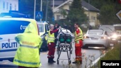 Emergency crews are seen near a stretcher after a shooting in al-Noor Islamic center mosque, near Oslo, Norway, Aug. 10, 2019. 