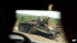FILE - A destroyed tank is seen by the side of the road south of Humera, in an area of western Tigray annexed by the Amhara region during the ongoing conflict, in Ethiopia, May 1, 2021. 