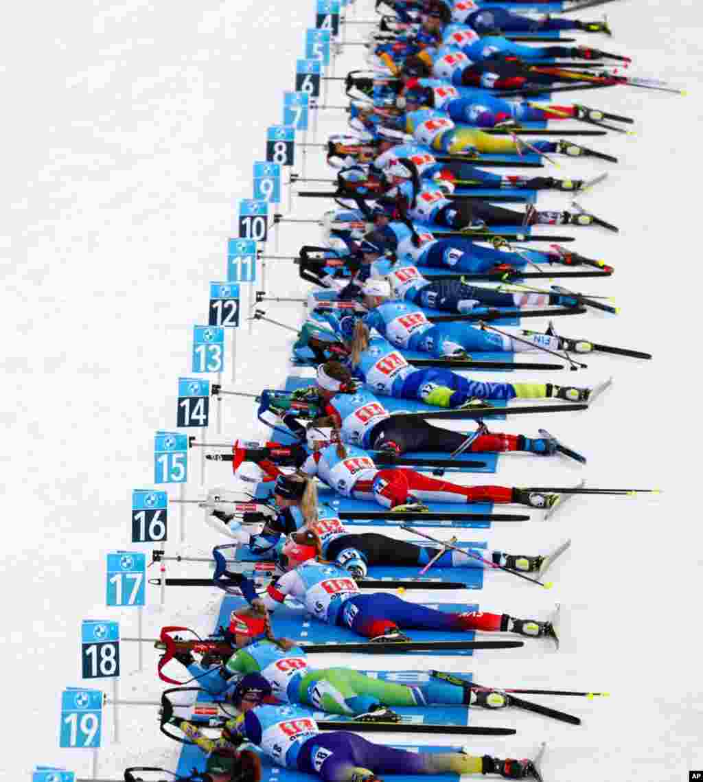 Athletes shoot during the mixed relay race at the Biathlon World Cup in Oberhof, Germany.