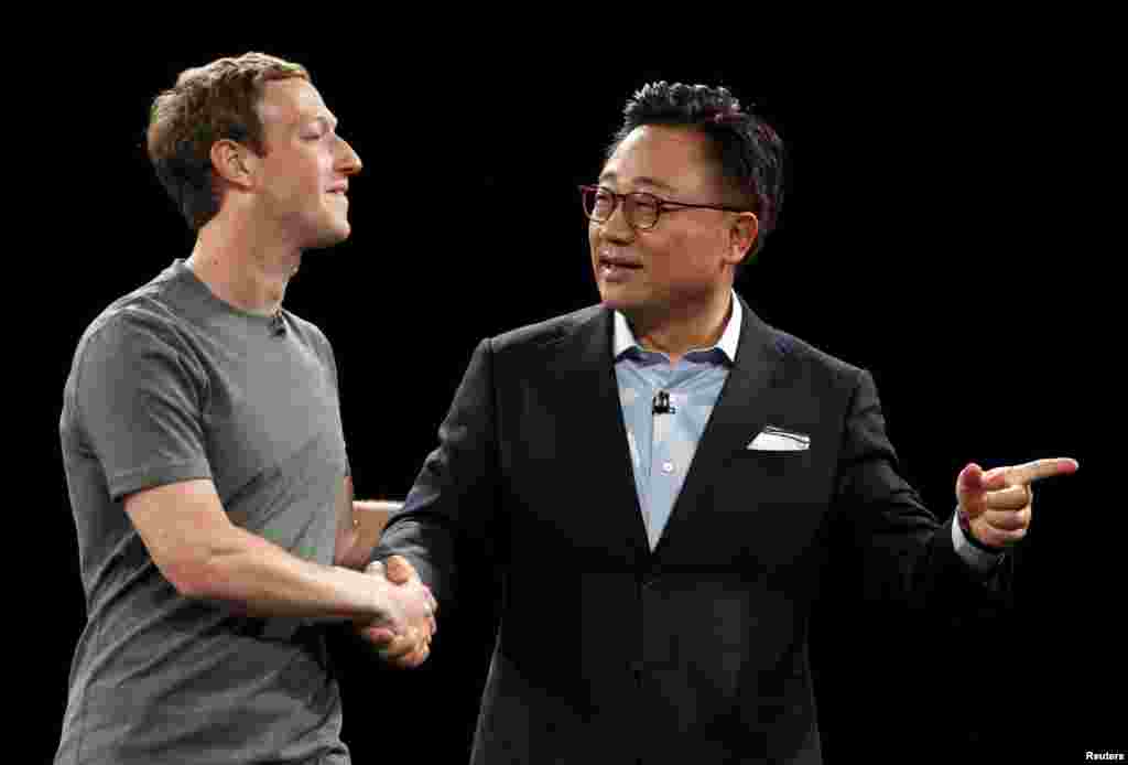 Mark Zuckerberg (L), founder of Facebook, is greeted by Samsung's Mobile Communications Business president, Dongjin Koh, during the unveiling ceremony of the Samsung S7 and S7 edge smartphones at the Mobile World Congress in Barcelona, Spain, Feb. 21, 201