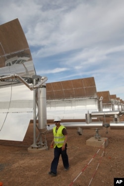 FILE—Pablo Ines, of Spain, walks in the building site of Morocco's Noor I solar power plant, near Ouarzazate, Morocco, April, 24, 2015 .