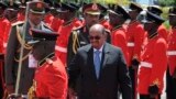 Sudan President Omar Bashir inspects the guard of honor after his arrival in Entebbe, Uganda, Nov. 13, 2017. Rights groups on Monday urged Ugandan authorities to arrest the visiting president of Sudan, who has long been wanted by the International Criminal Court for serious crimes. 