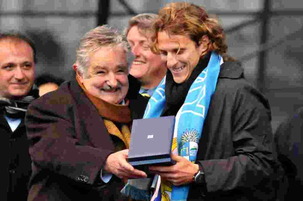 El presidente de Uruguay, José Mujica, entrega una medalla a Forlán por su actuación en la Copa Mundial Sudáfrica 2010.