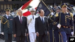 Lebanese President Michel Suleiman, second left, and French President Francois Hollande, second right, review honor guards, at the Presidential Palace in Baabda, east of Beirut, Lebanon, November 4, 2012.