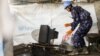 A U.N. peacekeeper takes part in a search for weapons and other restricted items at a camp for the displaced in Juba on Dec. 3, 2014. 