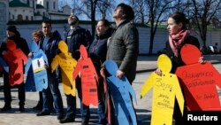 Activists take part in a flashmob to highlight human rights violations against Tatars living on the peninsula of Crimea, annexed by Russia two years ago, in Kiev, Ukraine, March 16, 2016.