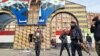 Anti-government fighters stand in front of a defaced portrait of Syrian President Bashar al-Assad as they patrol a street in the Syrian city of Daraa, Dec. 7, 2024.