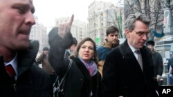 FILE - U.S. Assistant Secretary of State Victoria Nuland, center, and U.S. Ambassador to Ukraine Geoffrey Pyatt (r) walk through Independence Square in Kyiv, Dec. 10, 2013. 