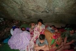 In this photo provided by Free Burma Rangers, villagers shelter in an undisclosed location due to Myanmar military's airstrikes, March 27, 2021, in Deh Bu Noh, in Karen state, Myanmar.