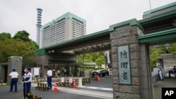 FILE - This photo shows an exterior view of the Defense Ministry of Japan with its sign at the main entrance in Tokyo on Sept. 17, 2021.