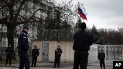 FILE - Bulgarian police officers stand guard in front of Russian embassy in Sofia, Bulgaria.
