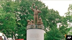FILE - In this July 10, 1996 file photo, a crowd gathers at the base of the Arthur Ashe Monument after the ceremony dedicating the statue on Monument Avenue in Richmond, Va. 