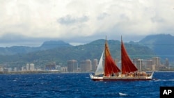 FILE - The Hokulea sailing canoe is seen off Honolulu, April 29, 2014. The Polynesian voyaging canoe is returning to Hawaii after a three-year journey around the world guided only by nature with navigators using no modern navigation to guide them.