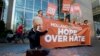 A man poses as crying firebrand anti-Islam lawmaker Geert Wilders during a small demonstration outside parliament, rear, in The Hague, Netherlands, March 16, 2017. 