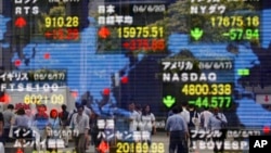 A securities firm's electronic stock indicator reflects pedestrians passing by in Tokyo, June 20, 2016. Global markets jumped Monday as polls suggest British voters on Thursday will choose to remain in the European Union. 