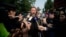 Outside a court in Beijing, Chinese artist Ai Weiwei (C) talks to the foreign media says the court rejected his appeal regarding a $2.4 million fine for tax evasion, Sept. 27, 2012.