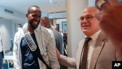 FILE - Sylvain Itte, right, French Ambassador to Niger, greets French journalist Olivier Dubois, at the airport in Niamey, Niger, March 20, 2023. 