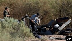 A French expert checks the remains of one of two helicopters that crashed near Villa Castelli, La Rioja province, Argentina, March 12, 2015.