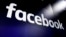 FILE - This March 29, 2018, photo shows the logo for Facebook on screens at the Nasdaq MarketSite, in New York's Times Square.