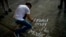 A student writes on a sidewalk with chalk "Fidel in the hearts of the med students" during a vigil for the late Cuban leader Fidel Castro at the university where Castro studied law as a young man in Havana, Cuba, Nov. 26, 2016.  