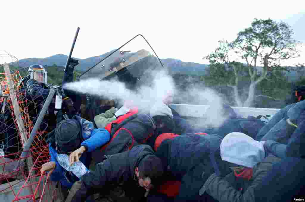 Members of Catalan protest group Democratic Tsunami clash with French police officers at the AP-7 highway on the French side of the Spanish-French border.