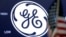 FILE - The General Electric logo appears above a trading post on the floor of the New York Stock Exchange, June 26, 2018. 