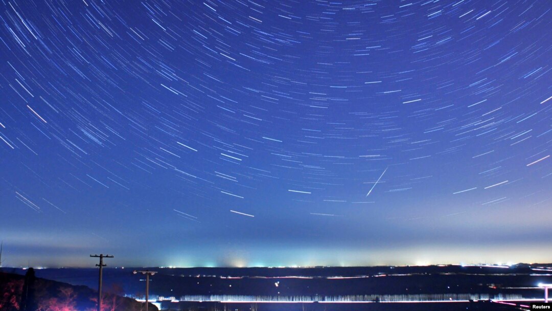 FILE - A meteor streaks past stars during the Quadrantid meteor shower in Qingdao, Shandong province, Jan. 4, 2014, in this photo taken with a long exposure. 