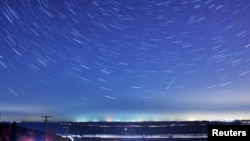 FILE - A meteor streaks past stars during the Quadrantid meteor shower in Qingdao, Shandong province, Jan. 4, 2014, in this photo taken with a long exposure. 