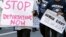 Immigration activists march in a rally against the U.S. Immigration and Customs Enforcement's (ICE) raids and deportation of immigrants near the downtown Los Angeles Federal Building, Jan. 26, 2016.