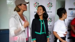 FILE - Boston mayoral candidates Annissa Essaibi George, left, and Michelle Wu, center, speak before the start of the Roxbury Unity Parade, in Boston's Roxbury neighborhood, July 18, 2021.