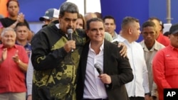 FILE - Venezuela's President Nicolas Maduro, left, and Alex Saab embrace during an event marking the anniversary of the 1958 coup that overthrew dictator Marcos Perez Jimenez, in Caracas, Venezuela, Jan. 23, 2024. Maduro has appointed Saab to his Cabinet.