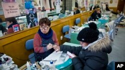 Lisa Moon, left, owner of Castle nail salon, manicures a customer at the salon she has owned for 16 years without "complaints," Jan. 8, 2015, in New York City.