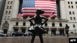 FILE - The Fearless Girl statue stands in front of the New York Stock Exchange in New York City, March 23, 2020. 