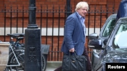 FILE - Former British foreign secretary Boris Johnson leaves his home at Carlton House Terrace, in central London, Britain, July 11, 2018.