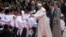 Colombia's President Juan Manuel Santos, second from right, and his wife Maria Clemencia Rodriguez accompany Pope Francis who is greeted by children upon his arrival to El Dorado airport in Bogota, Colombia, Sept. 6, 2017.