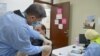 FILE - A Palestinian man receives the COVID-19 vaccine inside a medical center at Baqaa refugee camp, near Amman, Jordan April, 12, 2021.