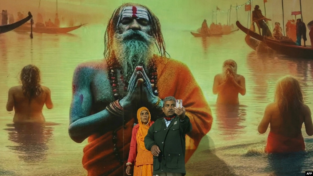 Hindu pilgrims takes a selfie as they arrive to take part in the Maha Kumbh Mela festival in Prayagraj on January 12, 2025.