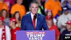 FILE - North Dakota Governor Doug Burgum speaks during the final campaign rally for then-presidential nominee Donald Trump before Election Day at Van Andel Arena in Grand Rapids, Michigan, Nov. 4, 2024. 