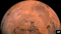 FILE - This image made available by NASA shows the planet Mars. This composite photo was created from over 100 images of Mars taken by Viking Orbiters in the 1970s.