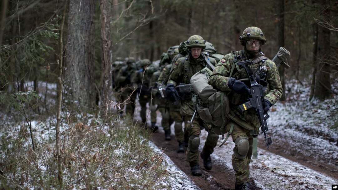 Lithuanian troops practice during a NATO military exercise, 'Iron Sword,' at the Rukla military base some 130 km. (80 miles) west of the capital Vilnius, Lithuania, on Monday, Nov. 28, 2016. (AP Photo/Mindaugas Kulbis)