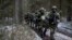 Lithuanian troops practice during a NATO military exercise, 'Iron Sword,' at the Rukla military base some 130 km. (80 miles) west of the capital Vilnius, Lithuania, on Monday, Nov. 28, 2016. (AP Photo/Mindaugas Kulbis)