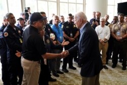 President Joe Biden shakes hands with Florida Chief Financial Officer Jimmy Patronis as he meets rescue teams and first responders who have worked at the site of a building collapse in Surfside, Fla., July 1, 2021.
